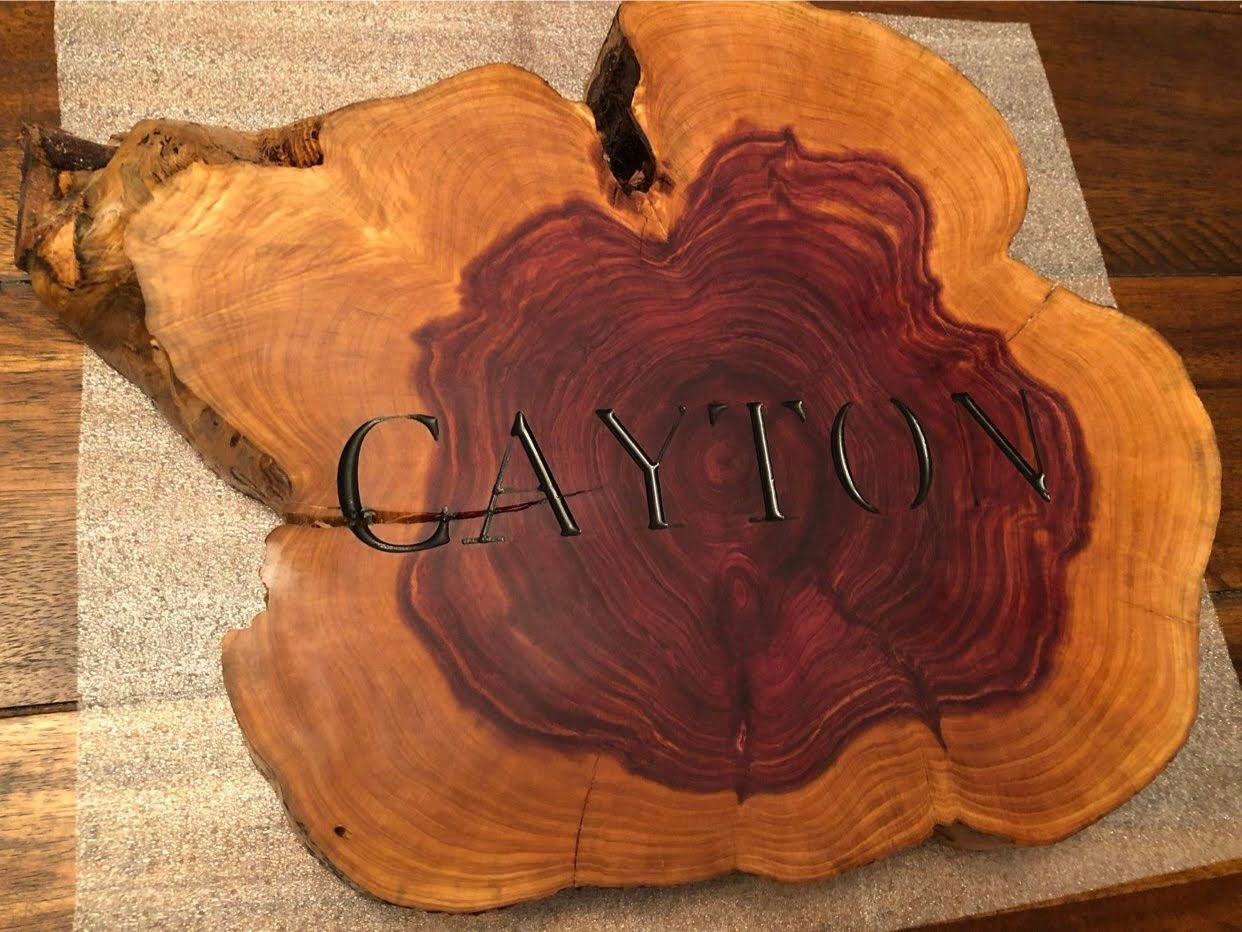 A piece of wood with the name gayton carved into it