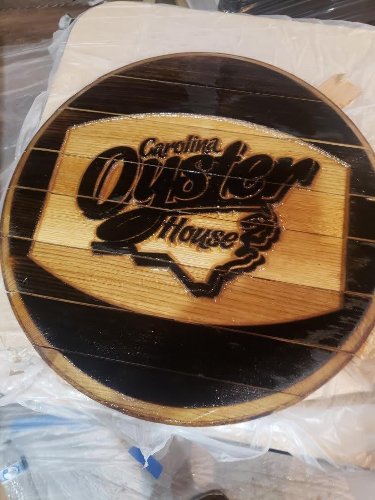 A wooden sign for the carolina oyster house