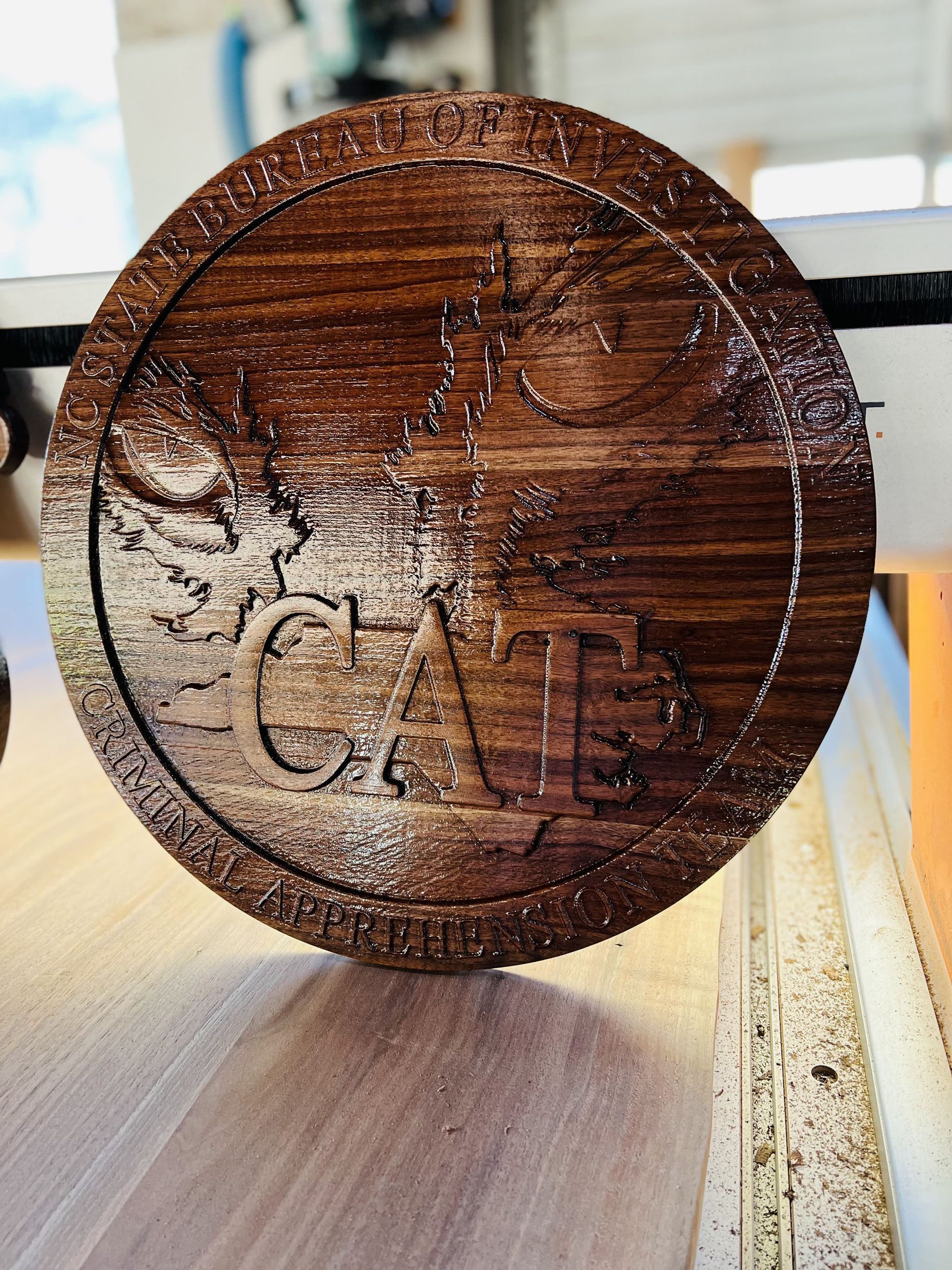 A wooden coin with the word cat carved into it