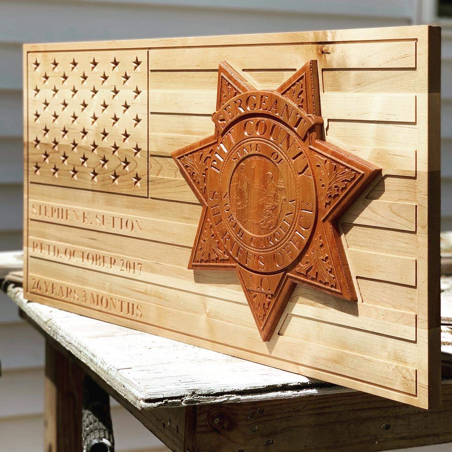 A wooden flag with a sheriff 's badge on it