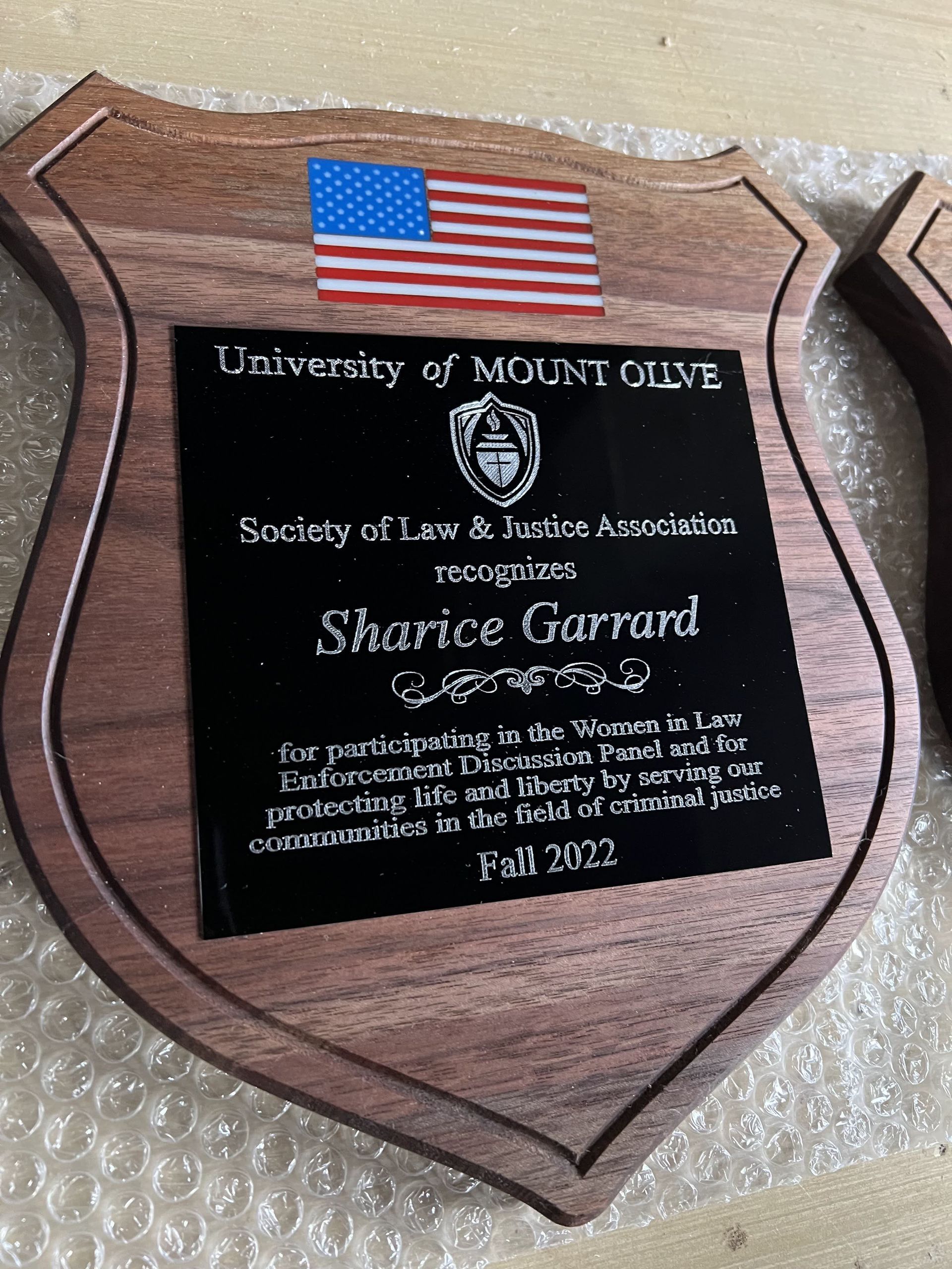 A wooden plaque with the name sharice garrard on it