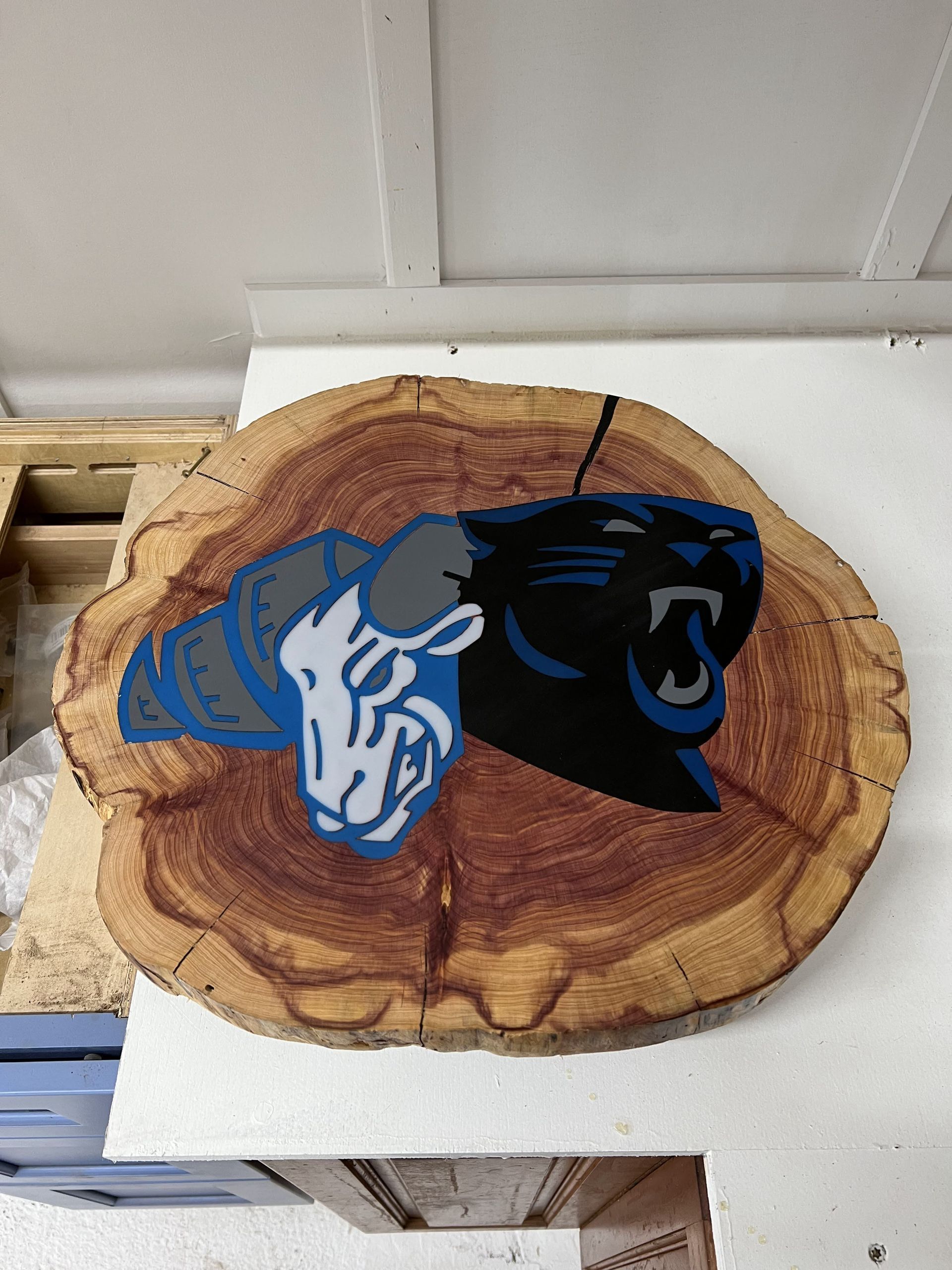 A piece of wood with a panther logo on it