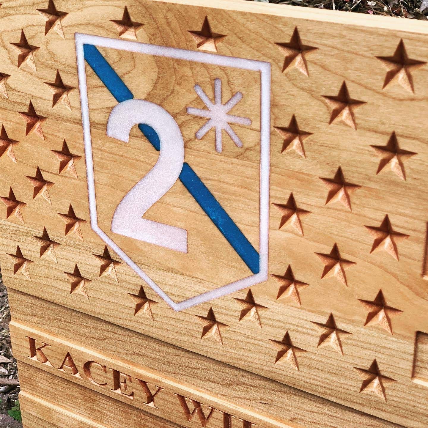 A wooden flag with the number 2 carved into it.