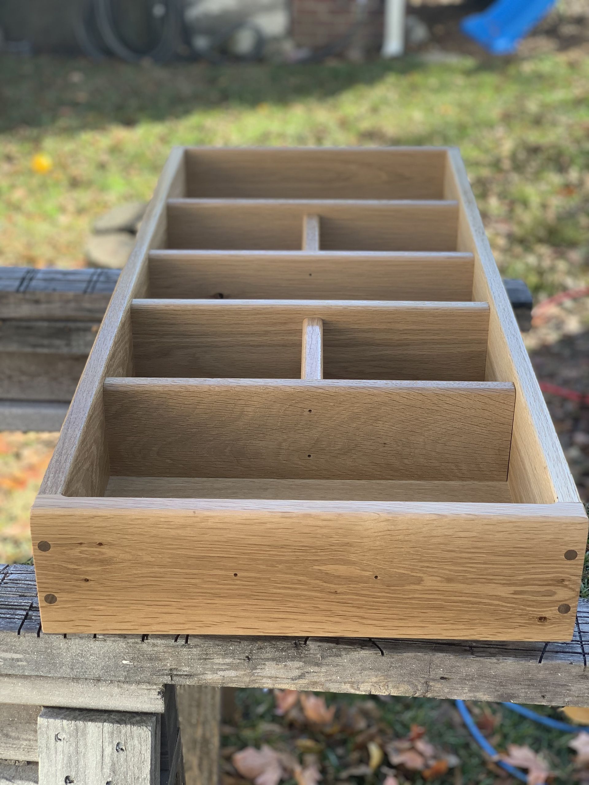 A wooden box is sitting on top of a wooden table.