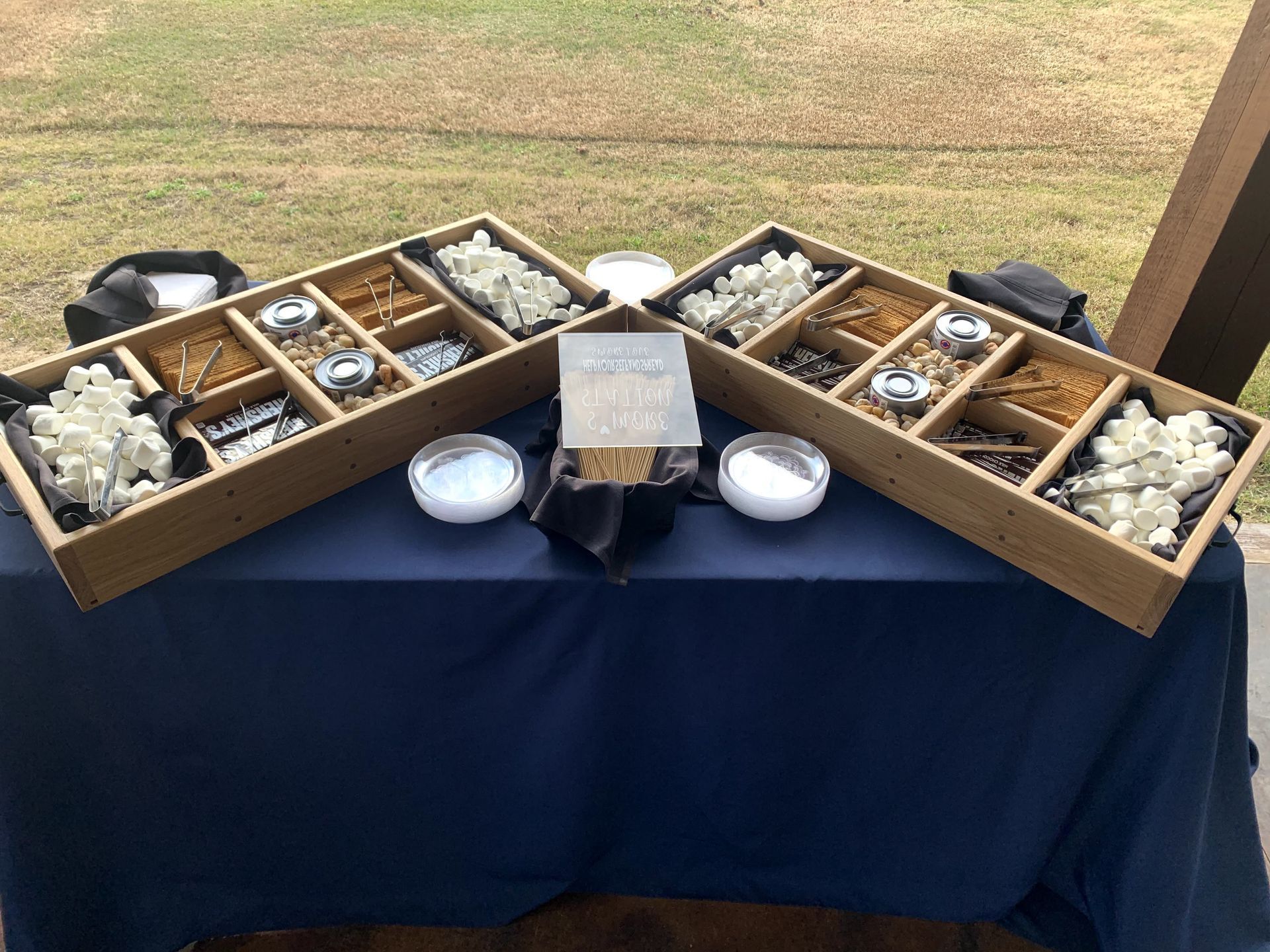 A table with two wooden boxes filled with food on it.