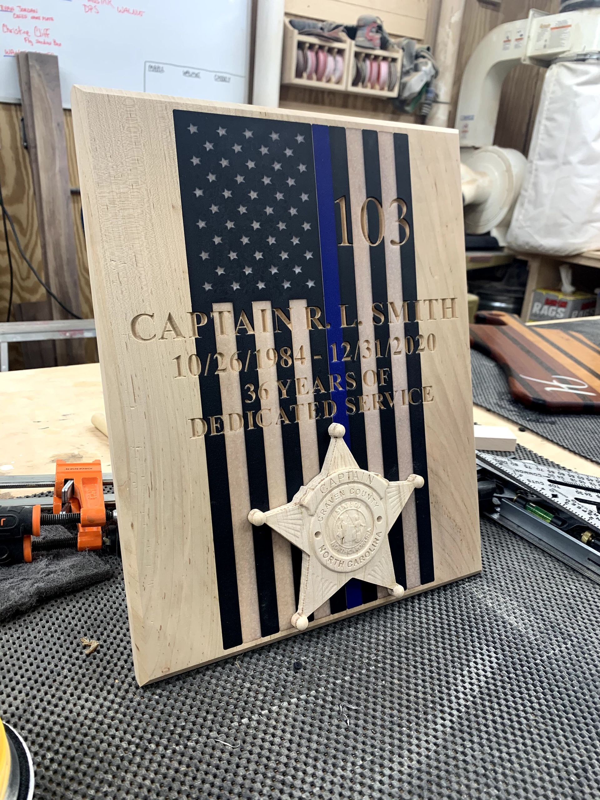 A wooden flag with a sheriff 's star on it