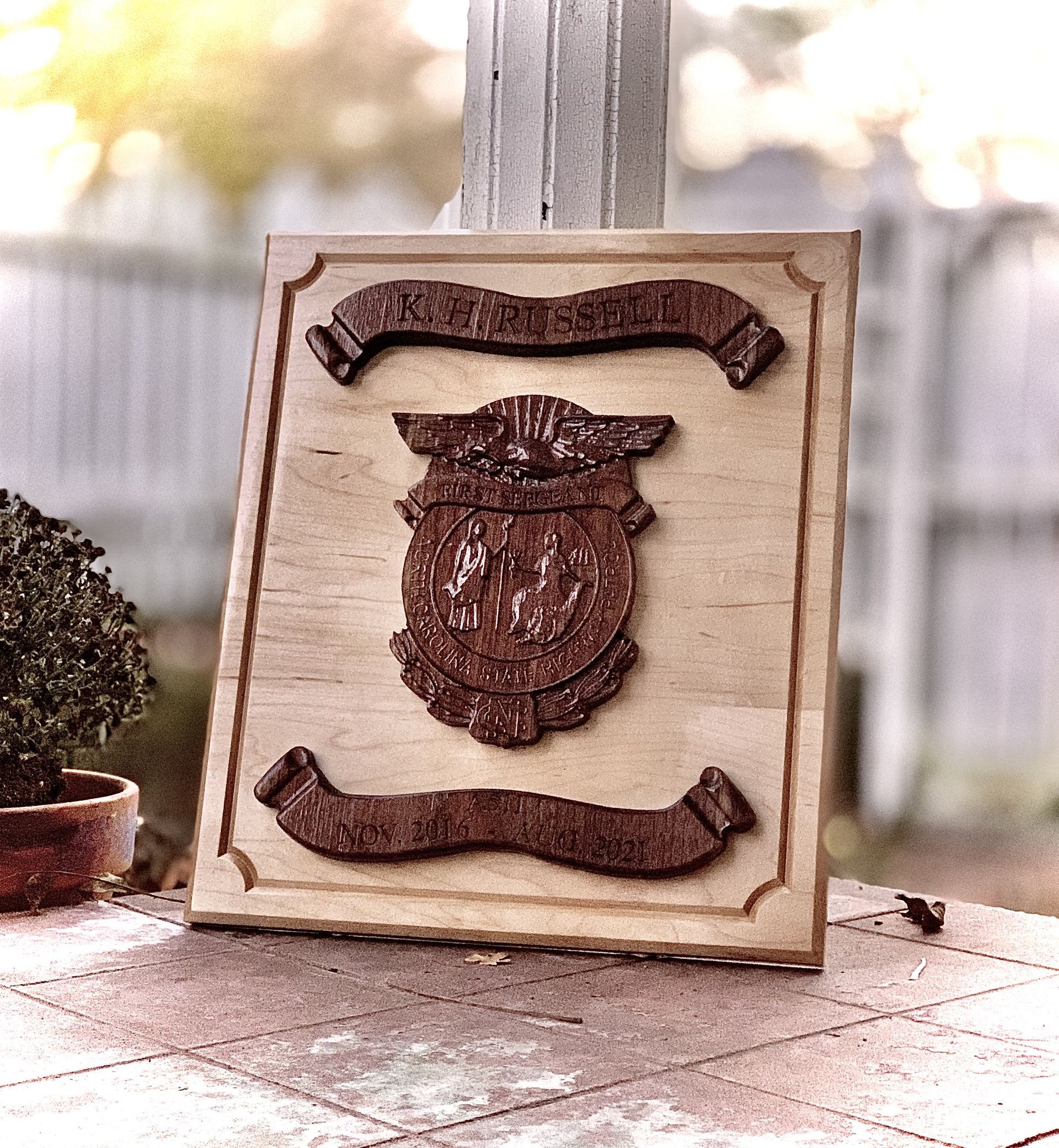 A wooden plaque with a coat of arms on it