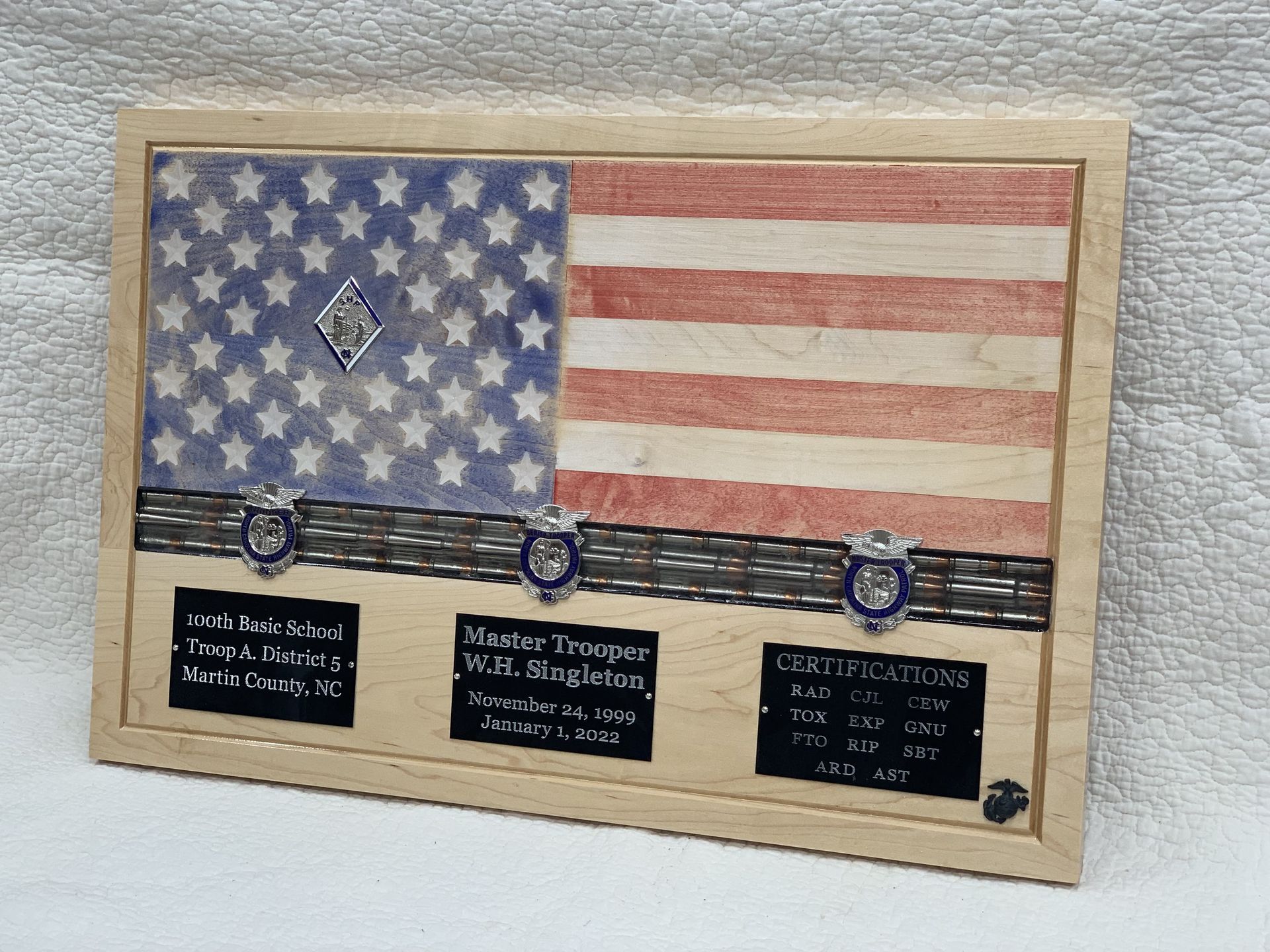 A picture of an american flag in a wooden frame