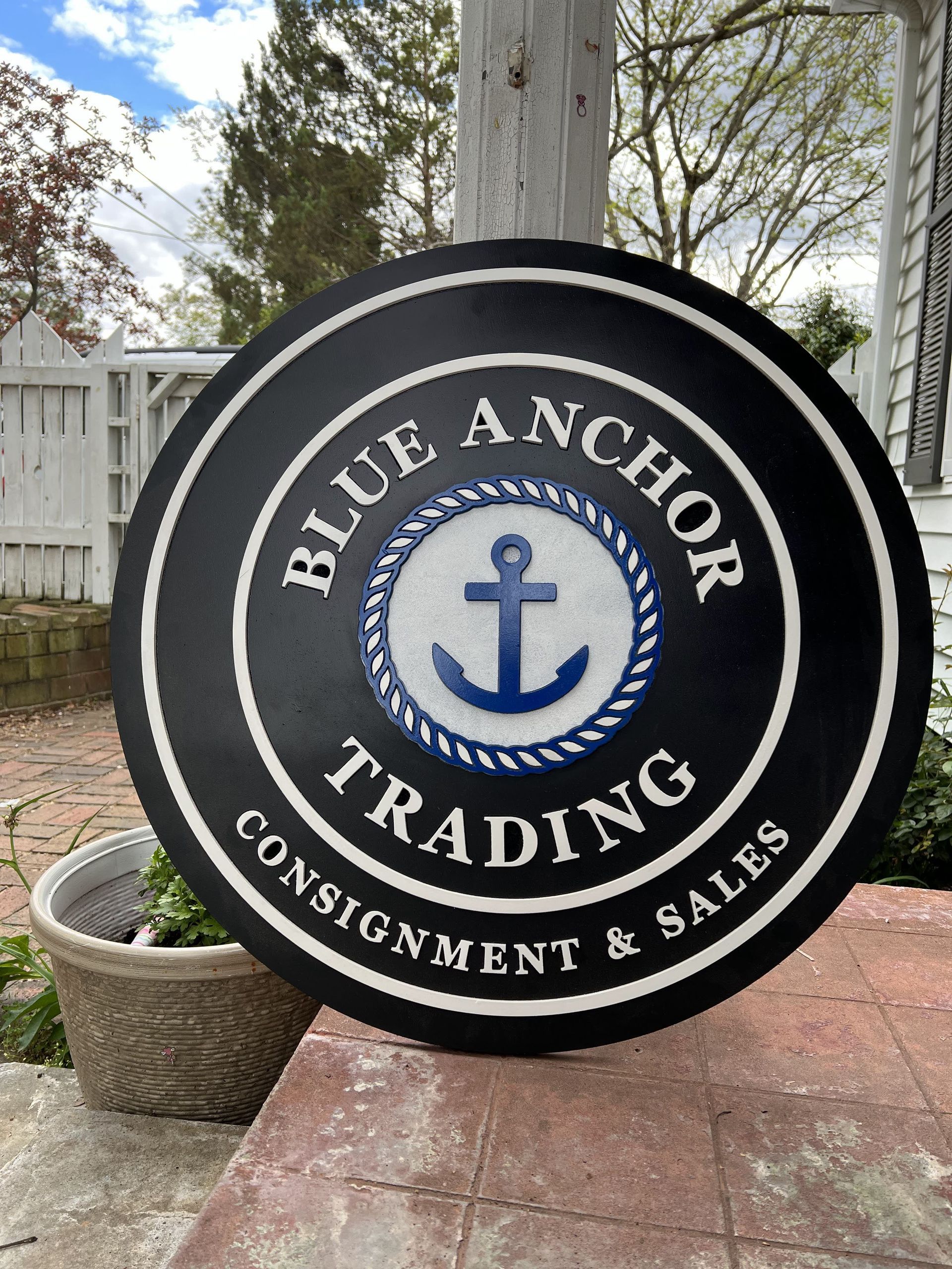 A sign that says blue anchor trading on it