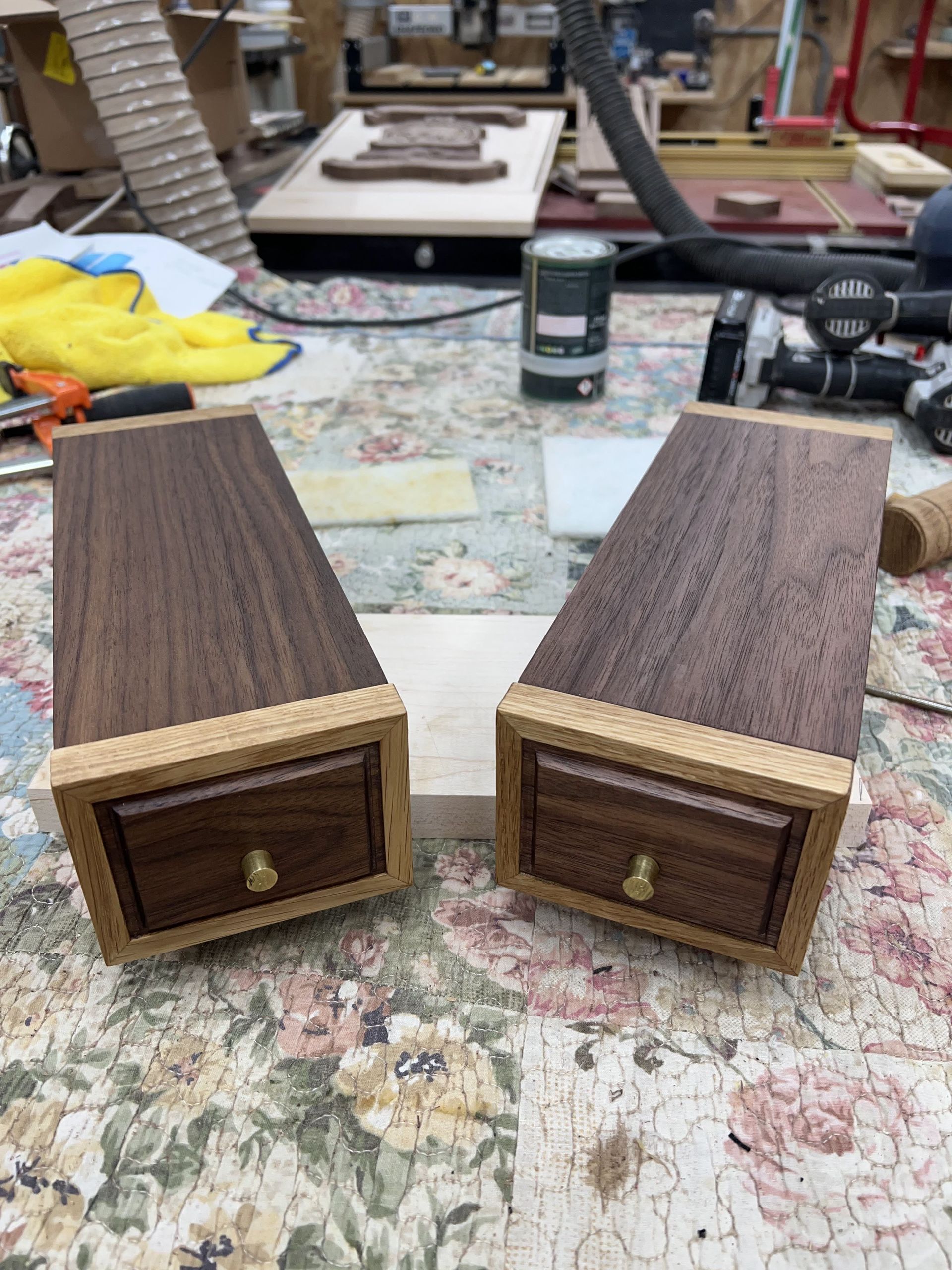 Two wooden boxes with drawers are sitting on a table.