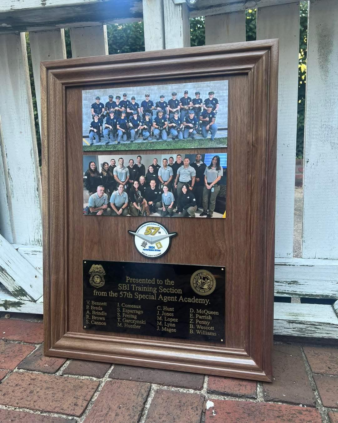 A framed picture of a group of people standing next to each other