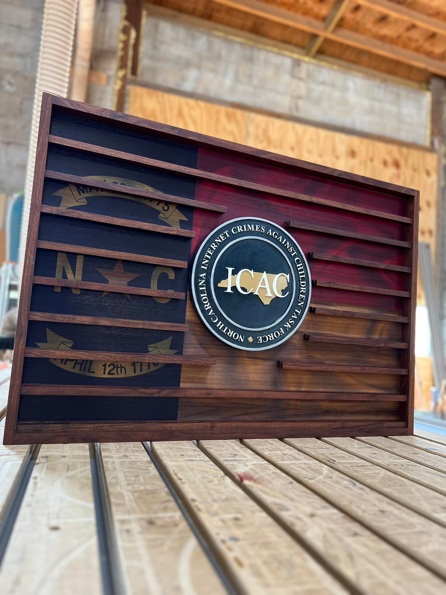 A wooden flag is sitting on top of a wooden table.