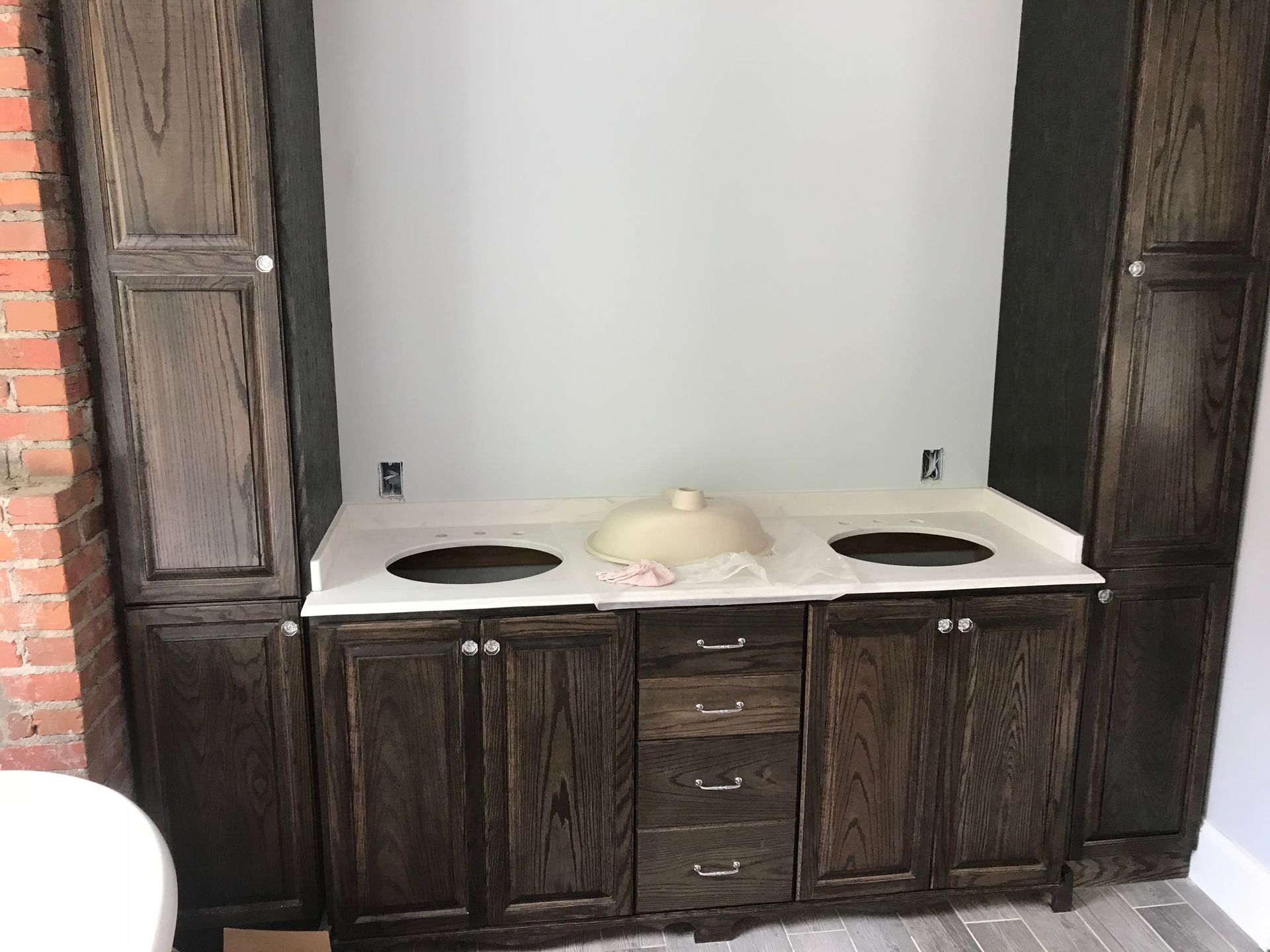 A bathroom with wooden cabinets and a sink