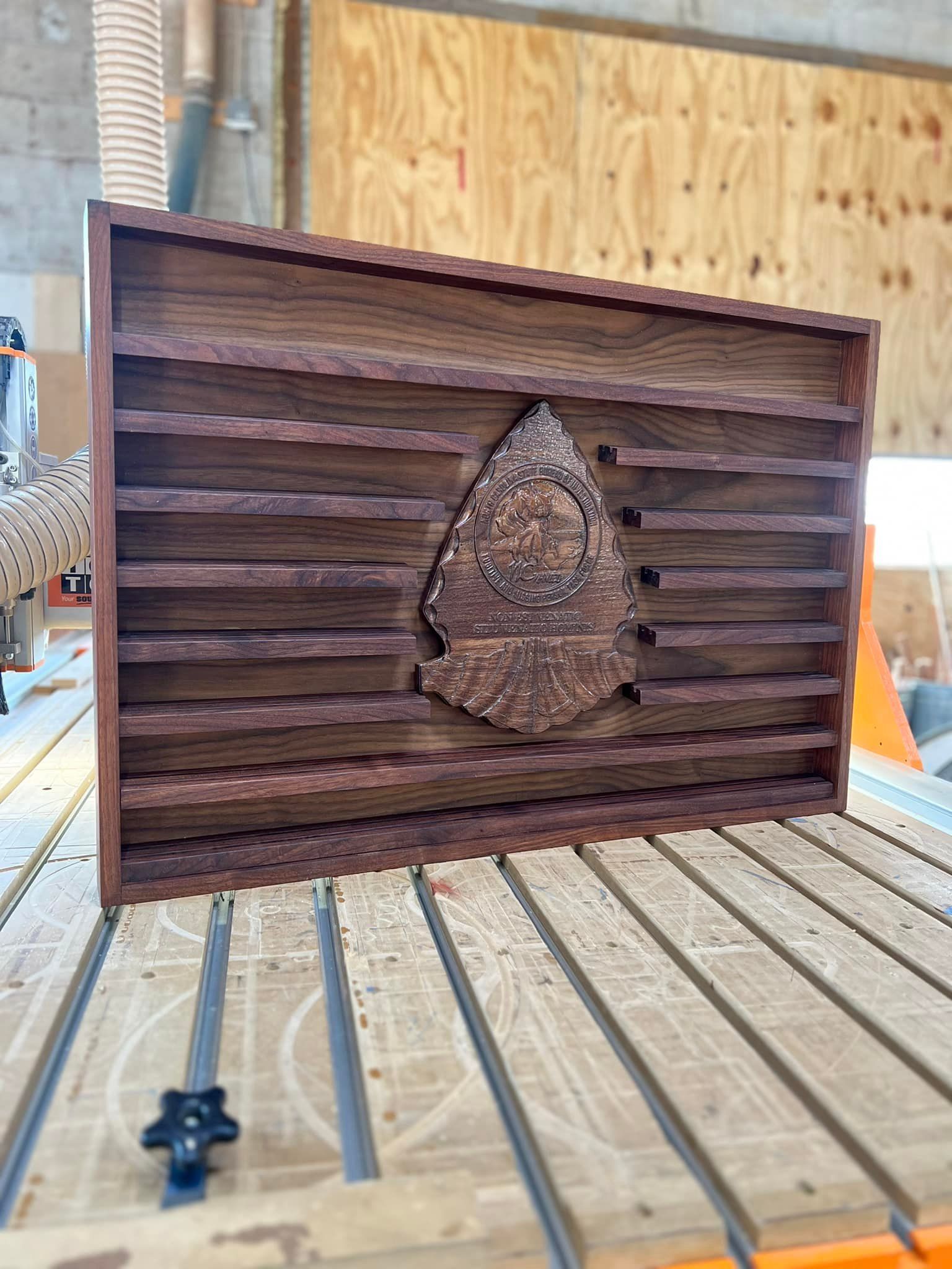 A wooden flag is sitting on top of a wooden table.