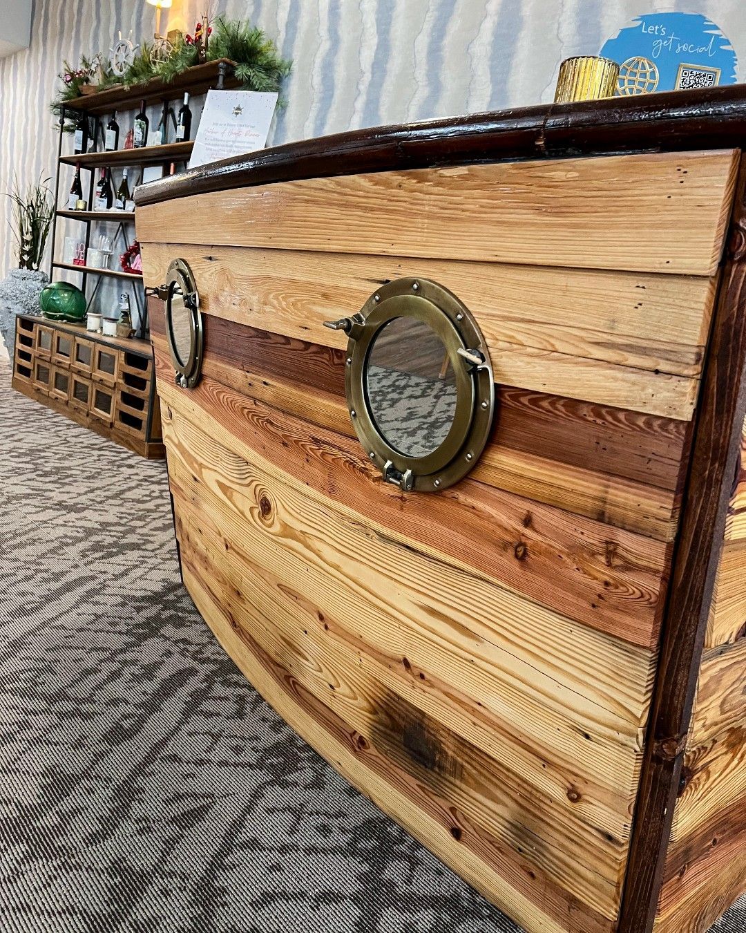 A wooden boat with a porthole on the side of it.
