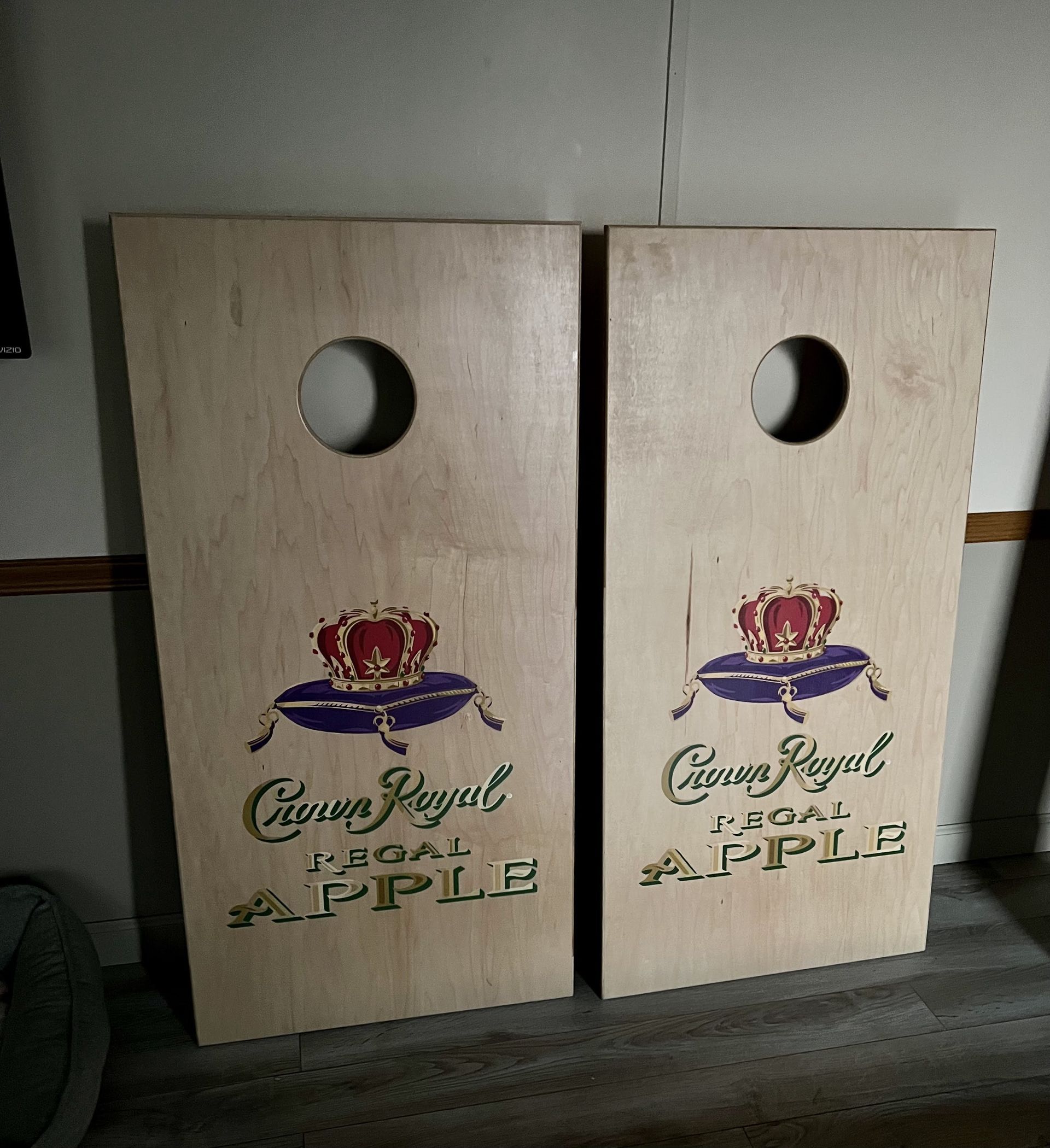Two cornhole boards with crown royal written on them