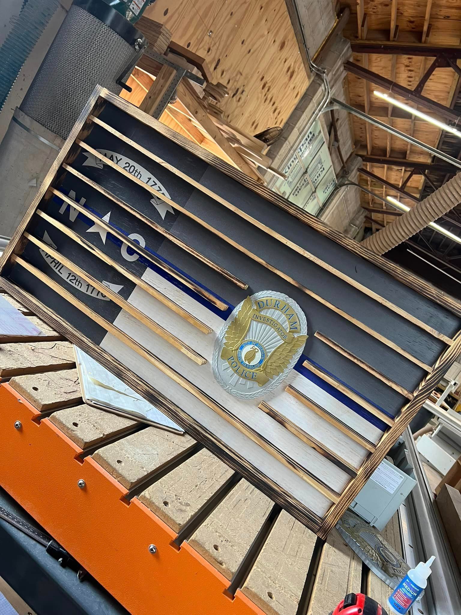 A wooden flag is sitting on top of a wooden table.