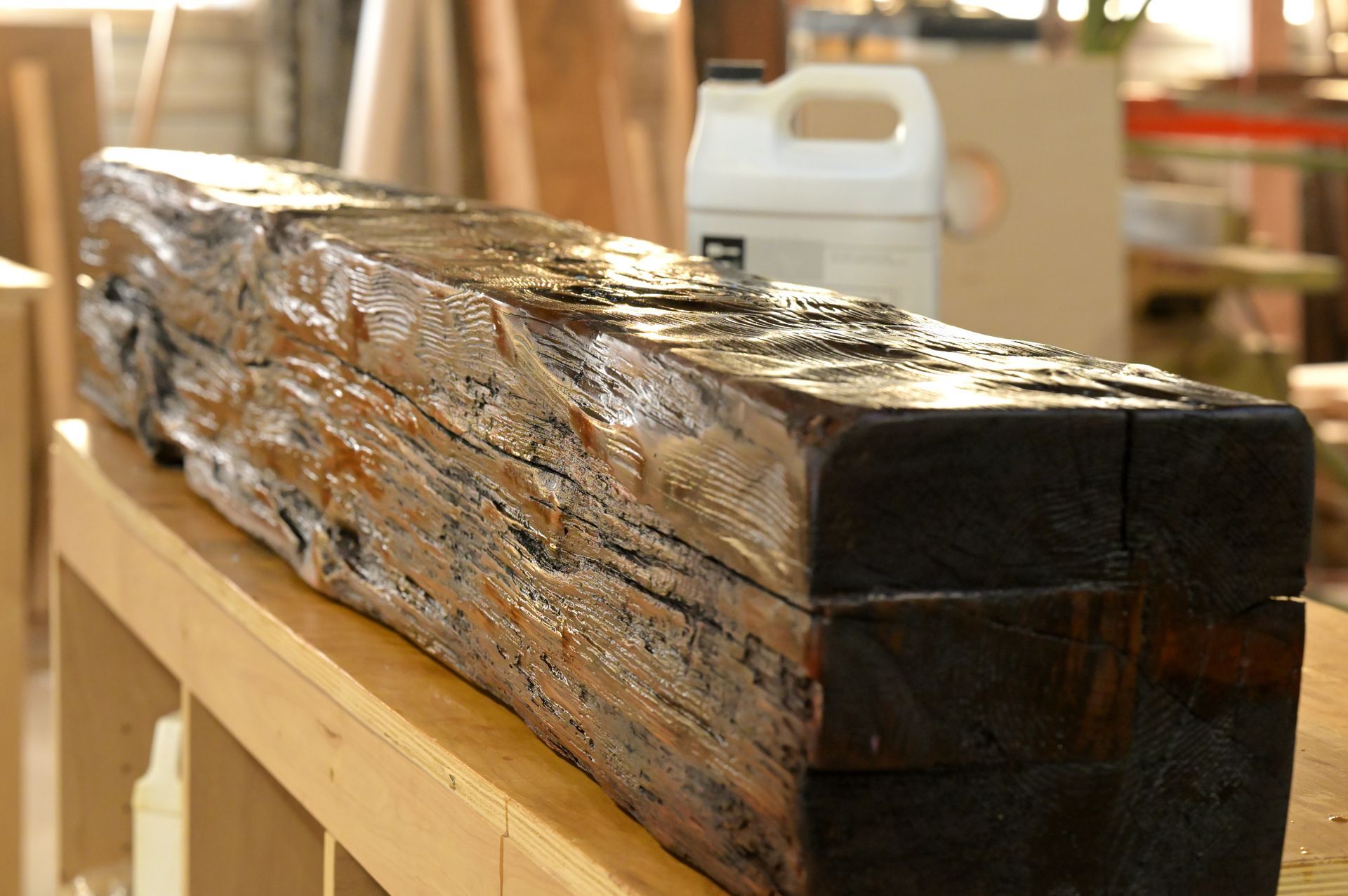 A large piece of wood is sitting on top of a wooden table.