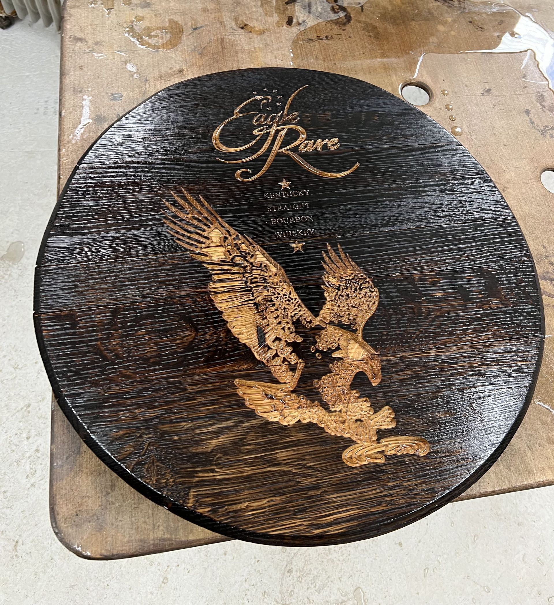 A wooden plate with a picture of an eagle on it
