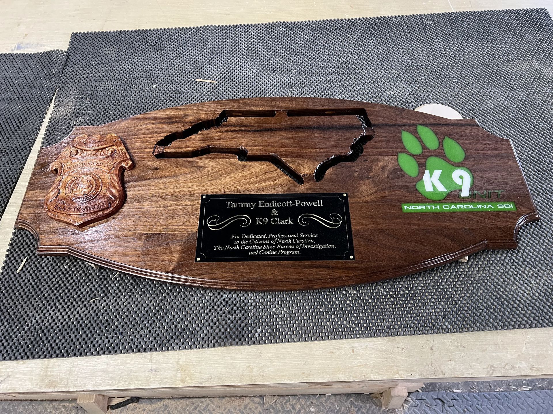 A wooden plaque with a map of north carolina on it