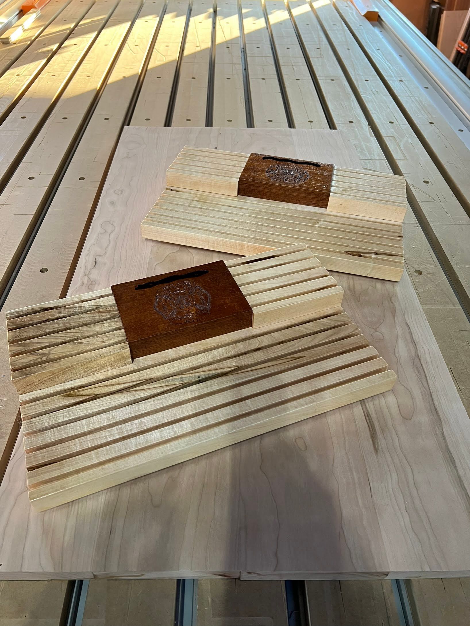Three pieces of wood are sitting on top of a wooden table.