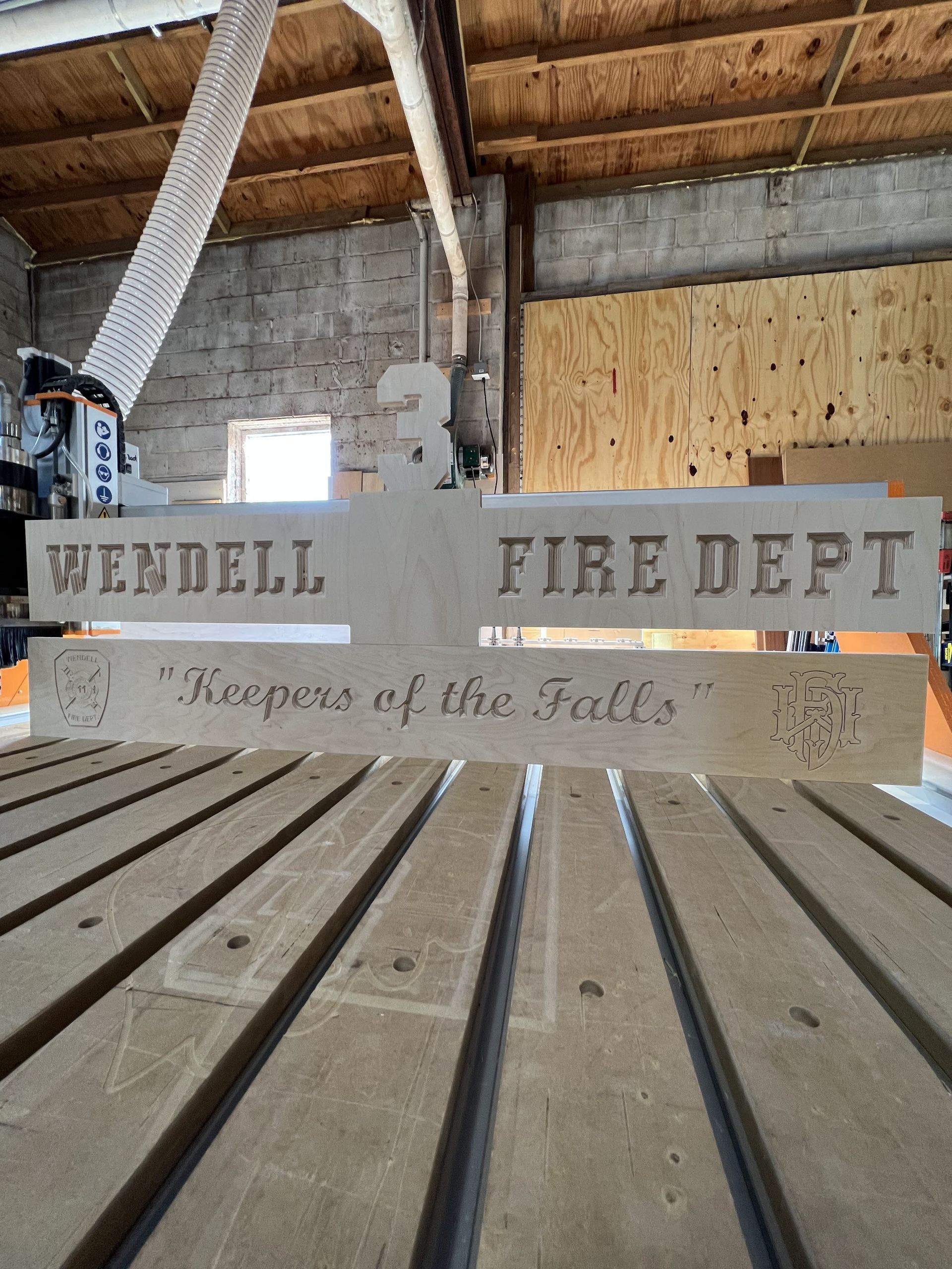 A wooden sign that says wendell fire dept on it