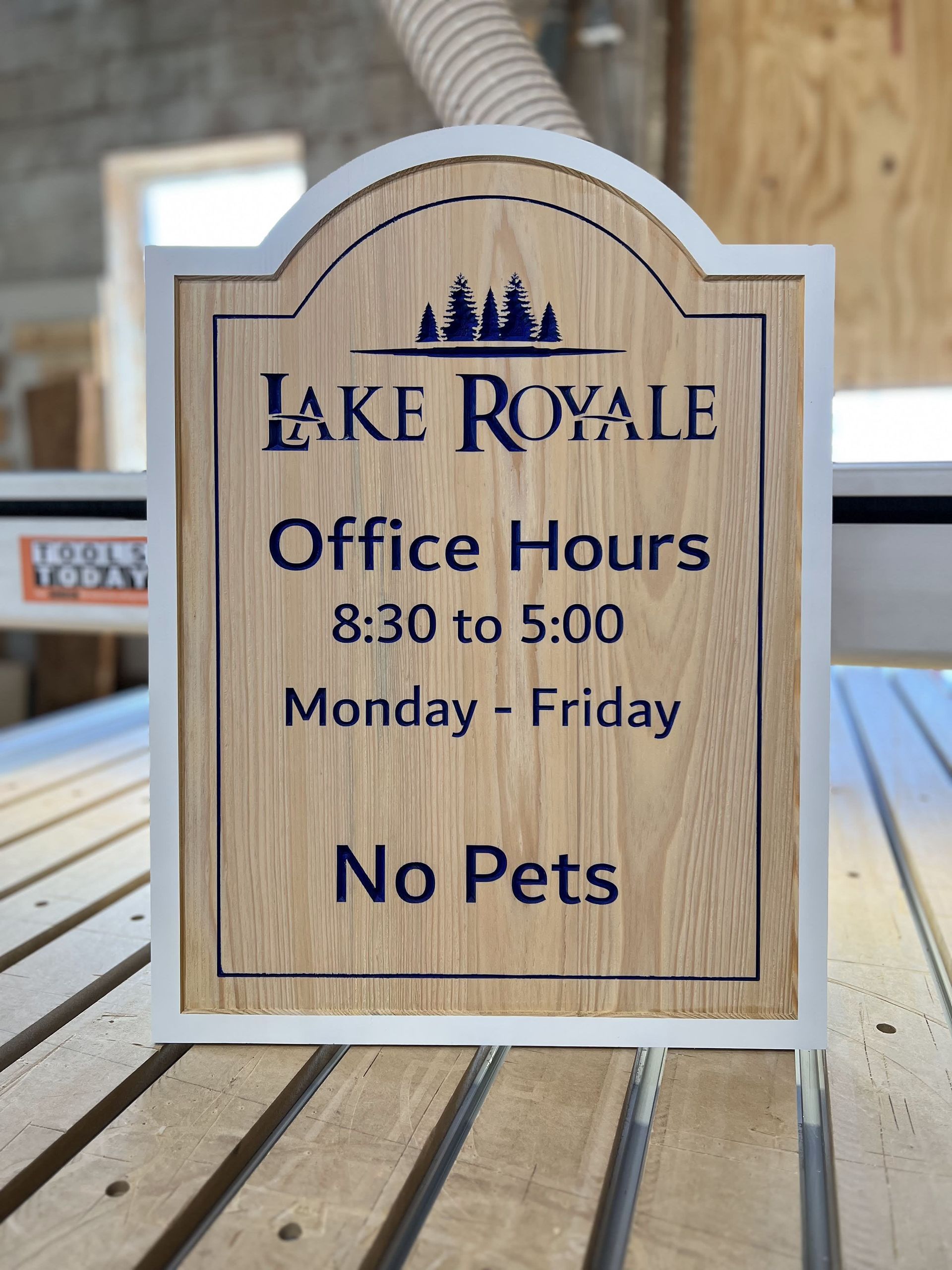A sign that says lake royale office hours on it