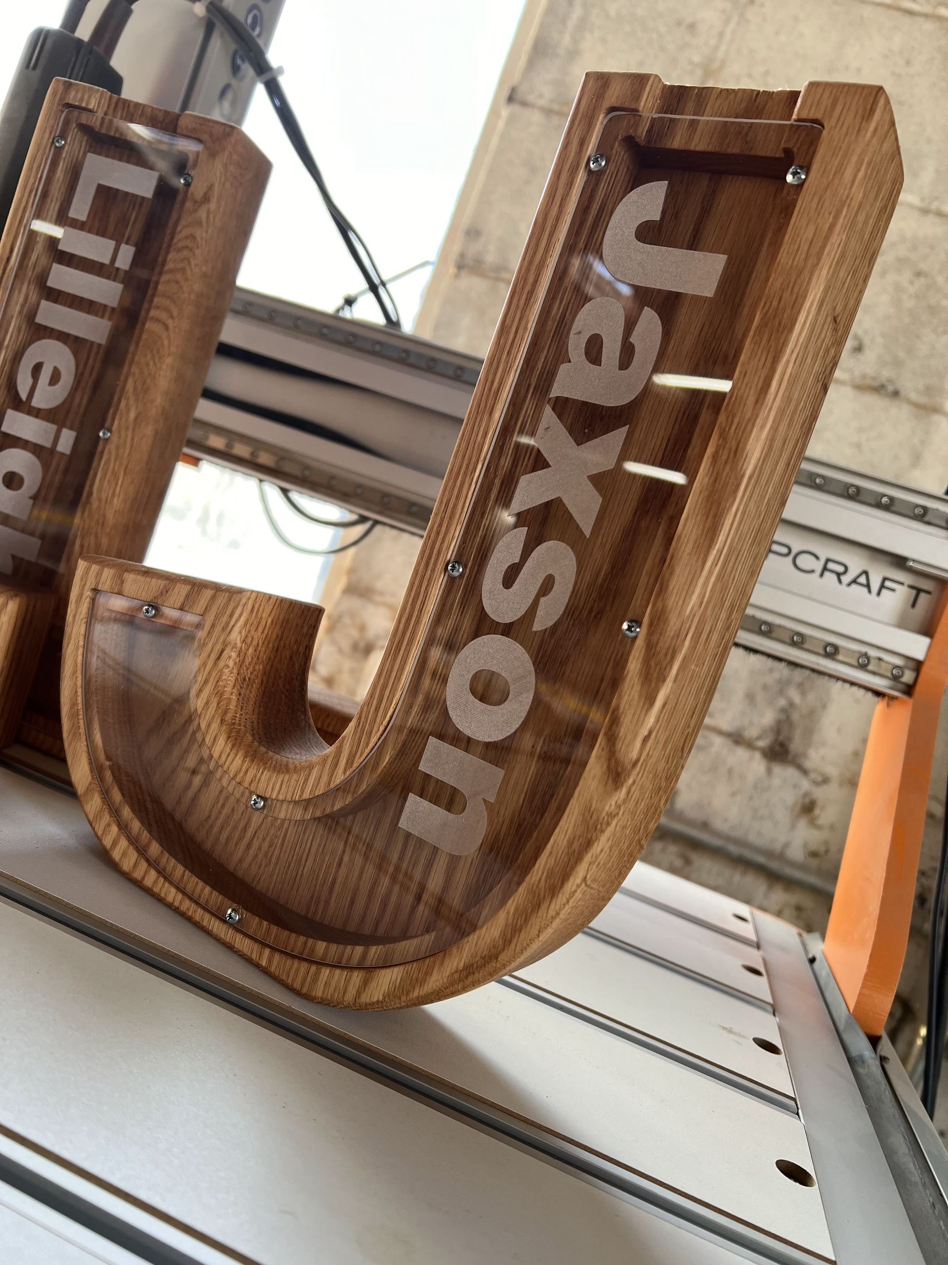 A wooden letter u with the name jaxson on it