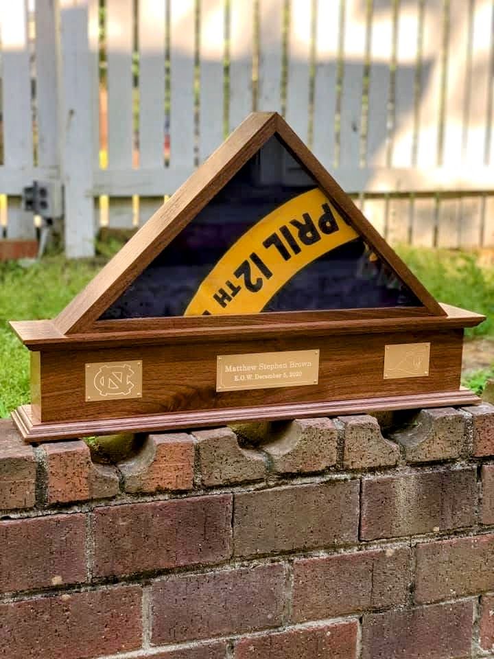 A wooden display case with the date april 12th on it