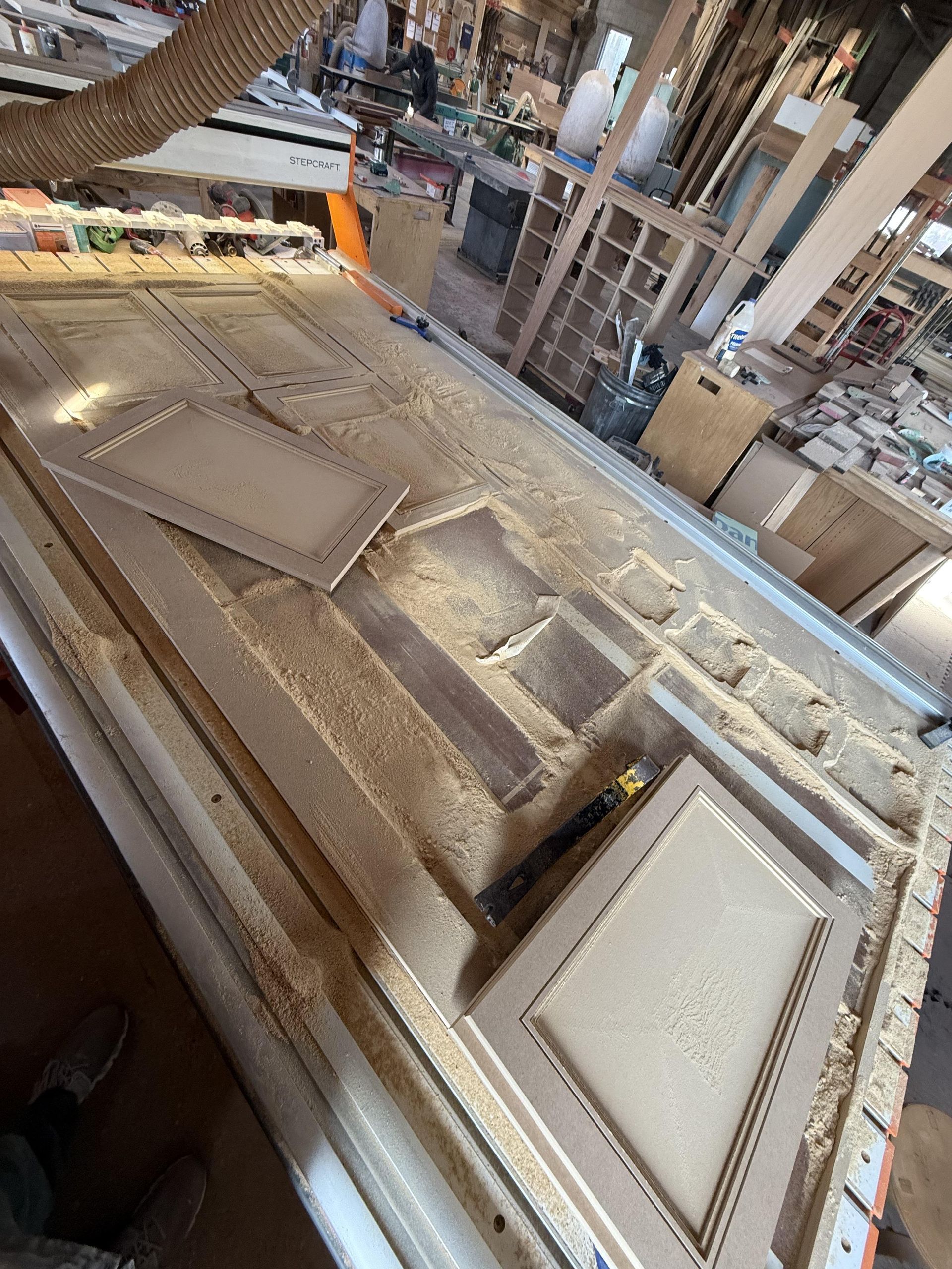 A piece of wood is sitting on top of a table in a woodworking shop.
