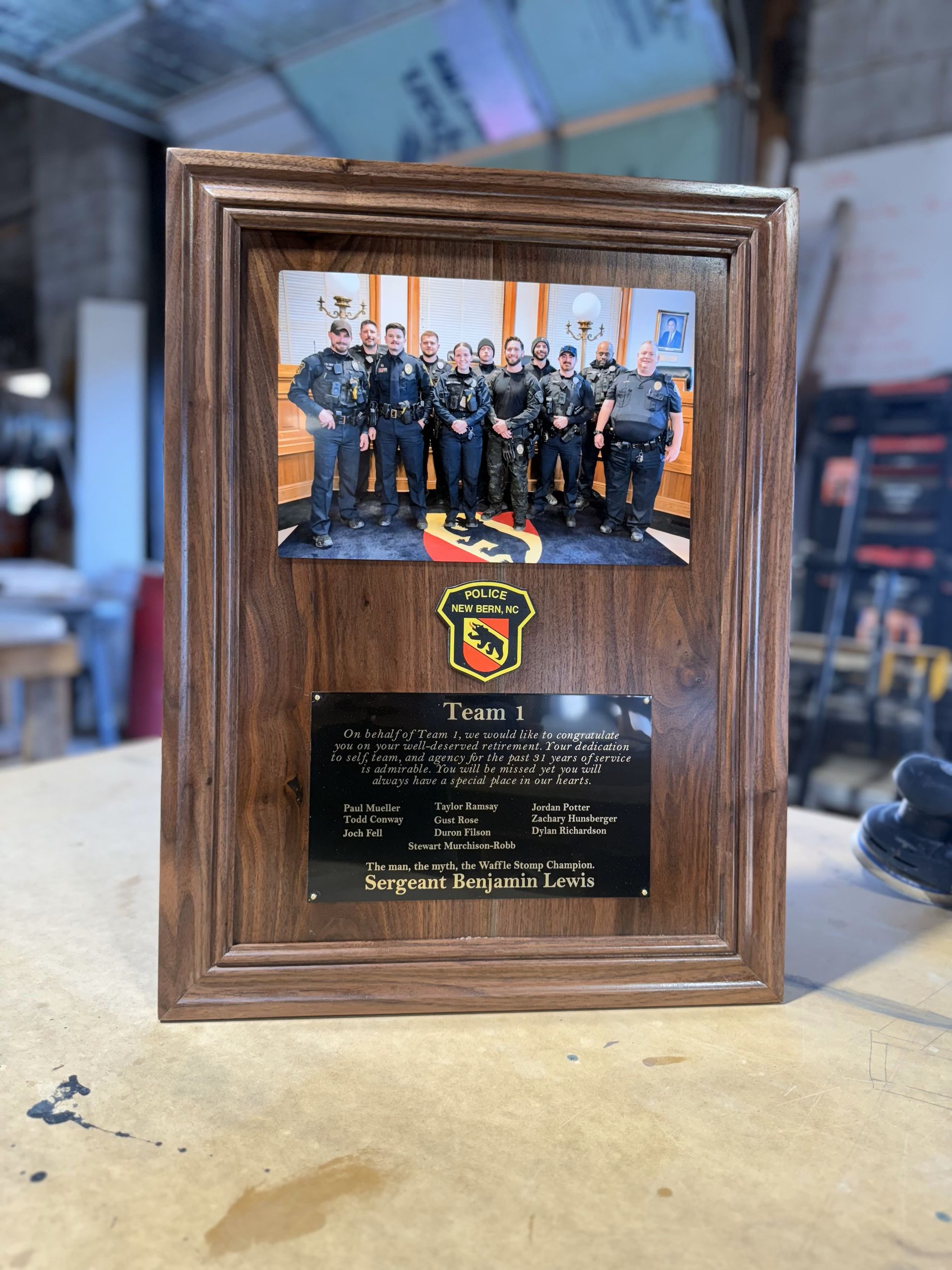 A wooden plaque with a picture of a group of police officers on it