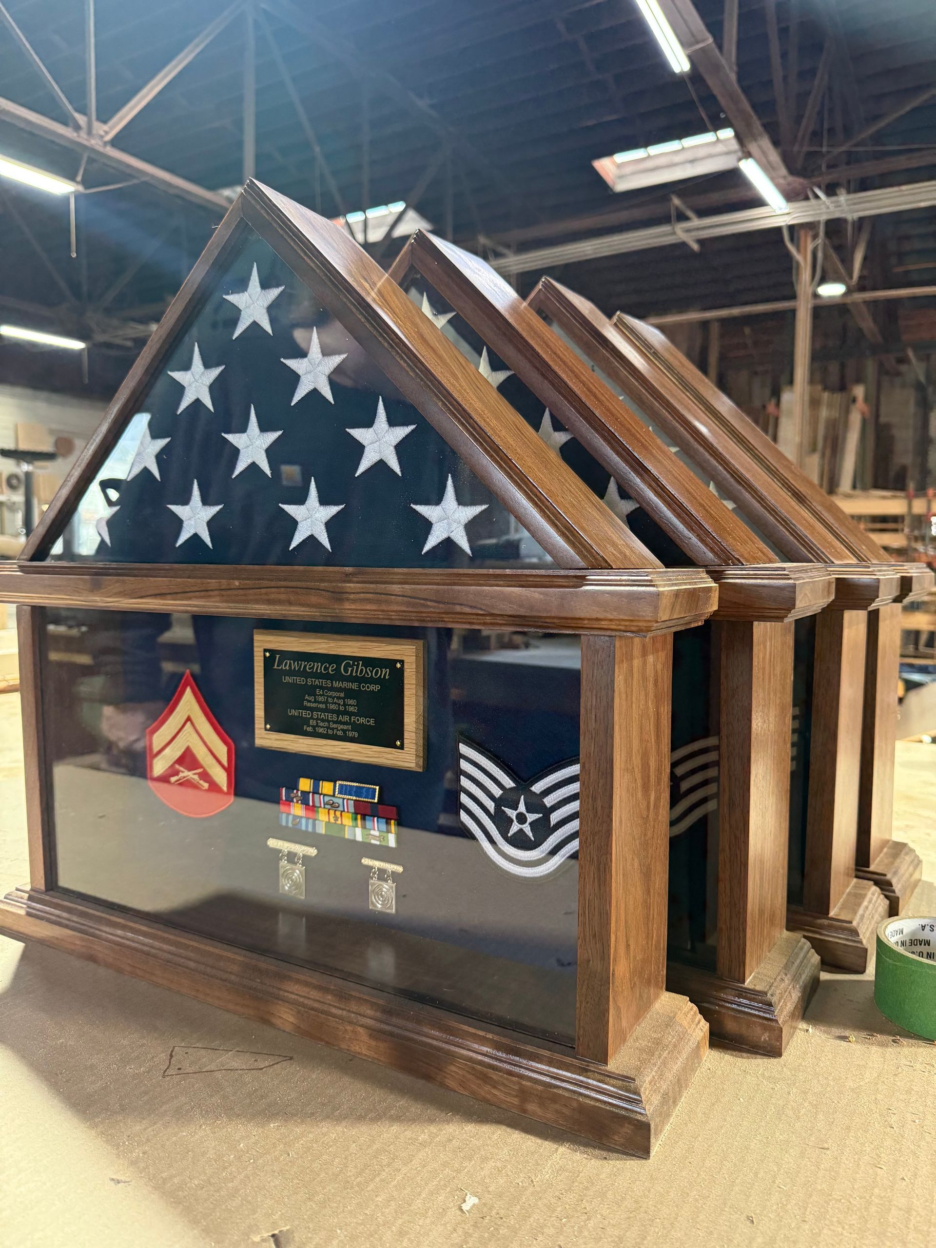 A wooden display case with an american flag inside of it.