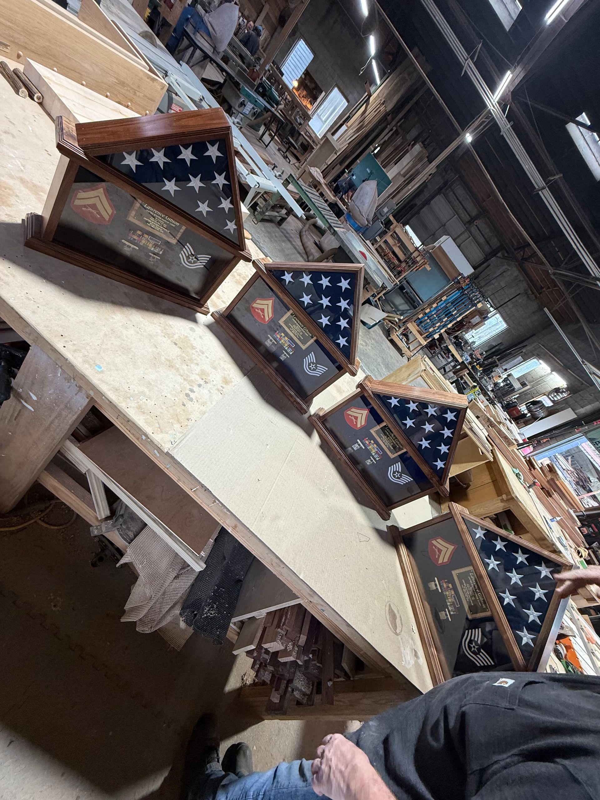 A man is sitting at a table with a bunch of flags on it.