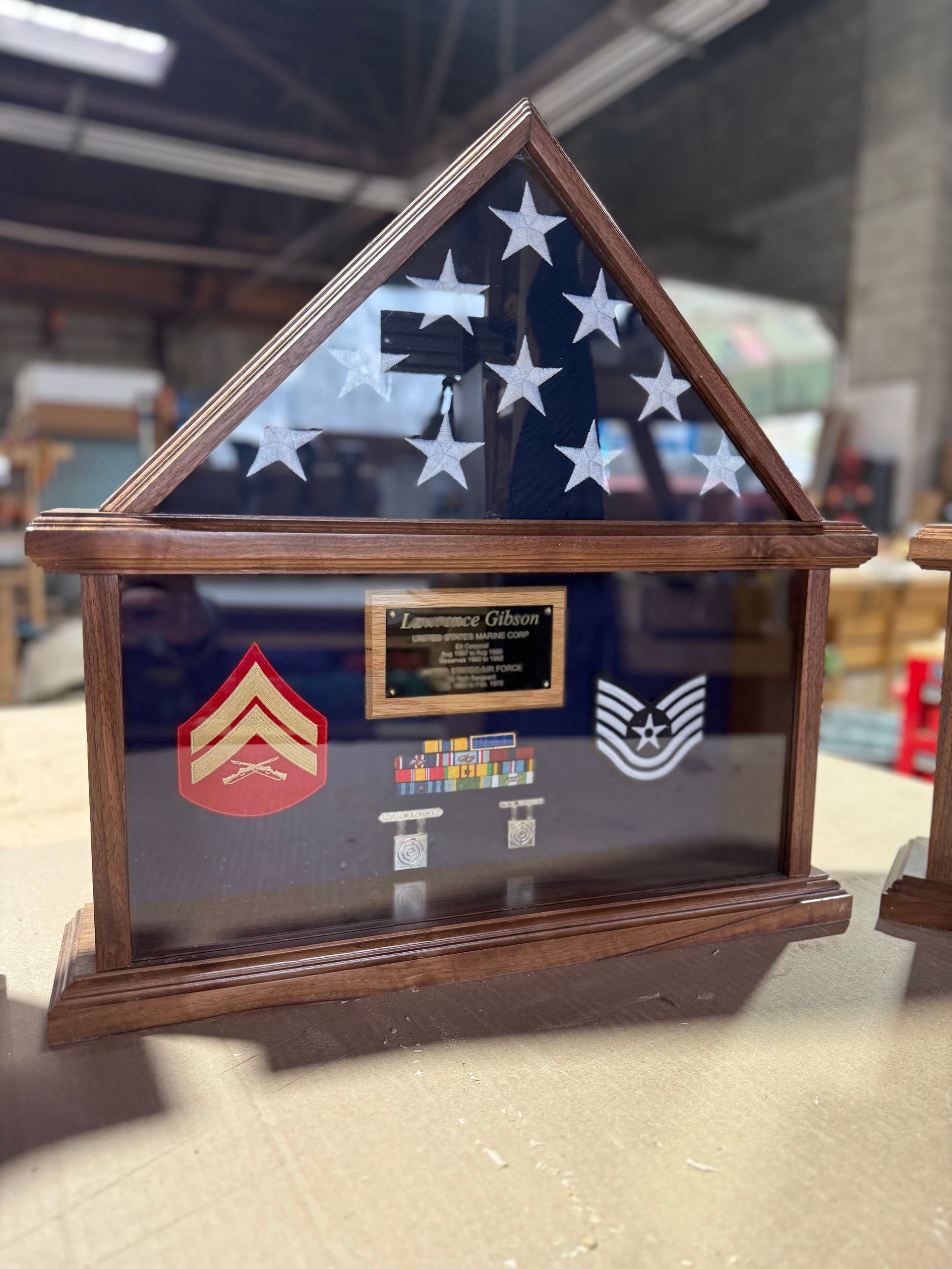 A small wooden display case with a flag inside of it.
