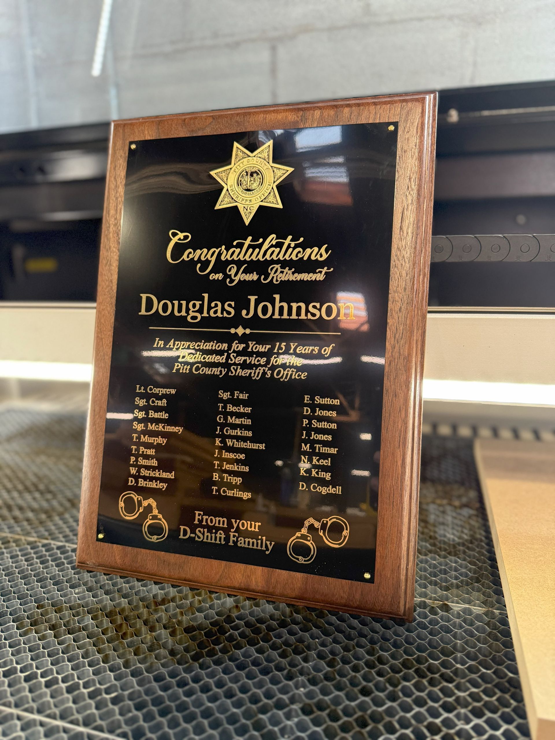 A wooden plaque with the name douglas johnson on it