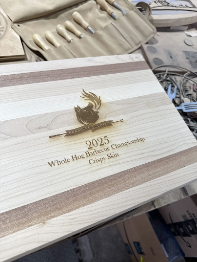 A wooden cutting board with a picture of a chicken on it.