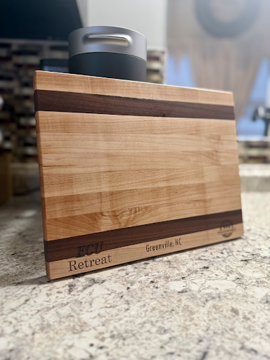 A wooden cutting board is sitting on top of a counter.