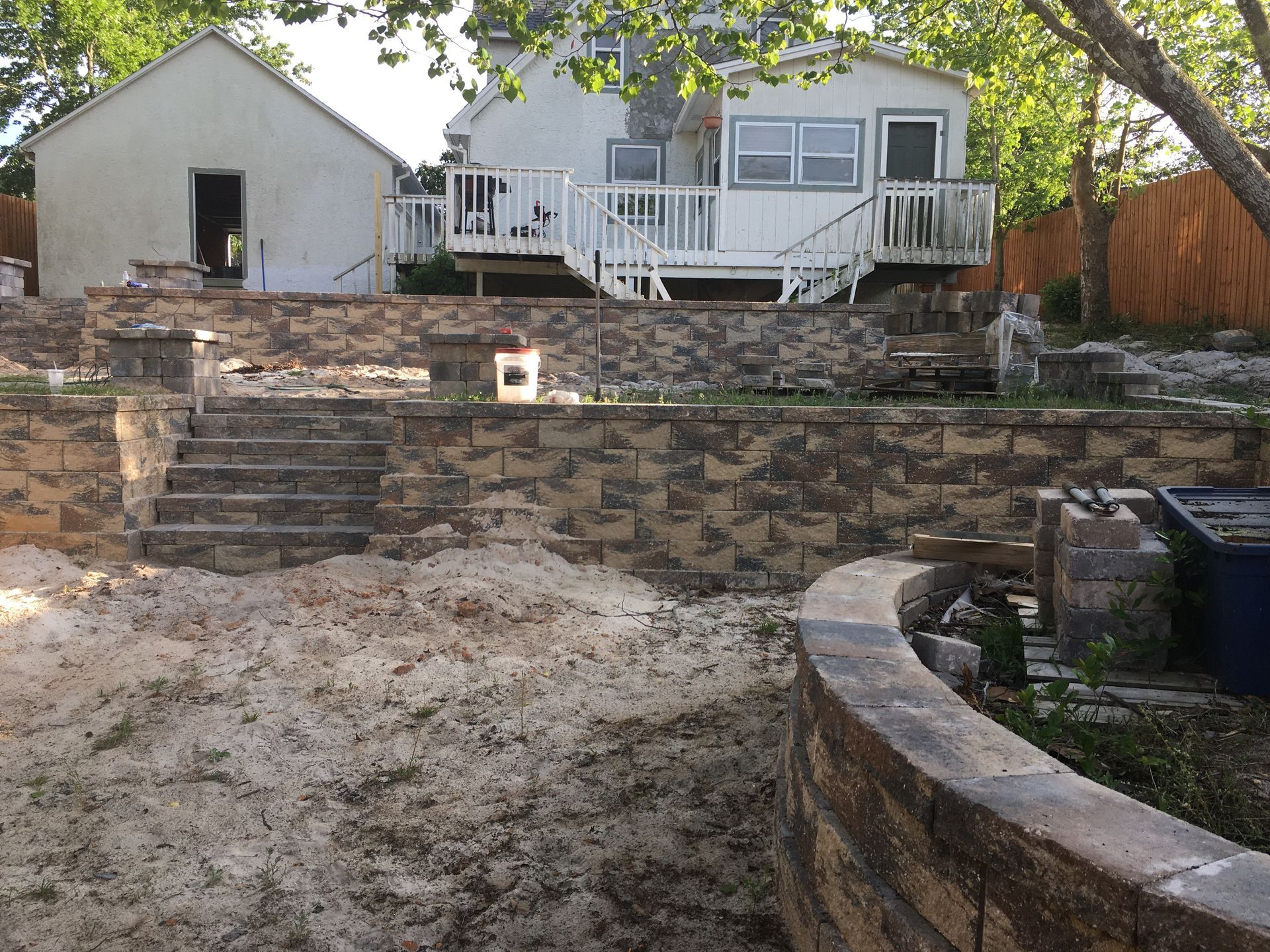 A house with a stone wall in front of it