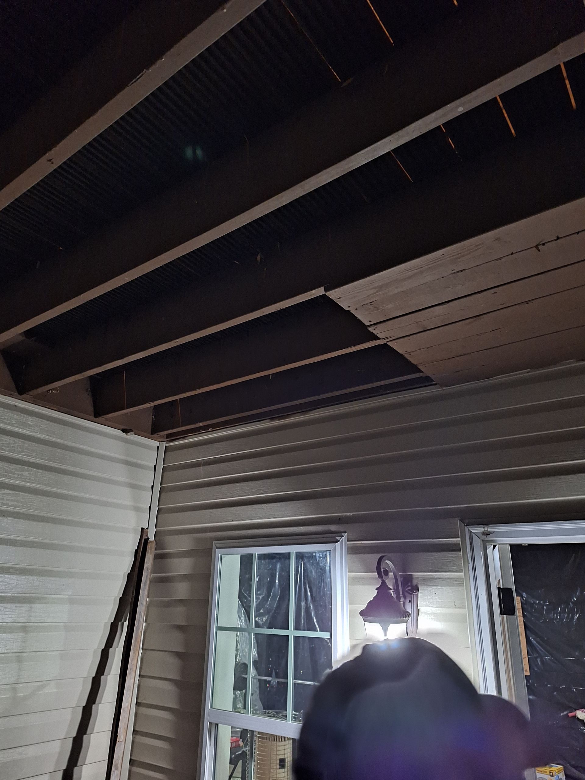 A person is looking up at the ceiling of a house.