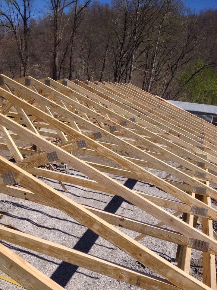 The roof of a building is being built with wooden beams.