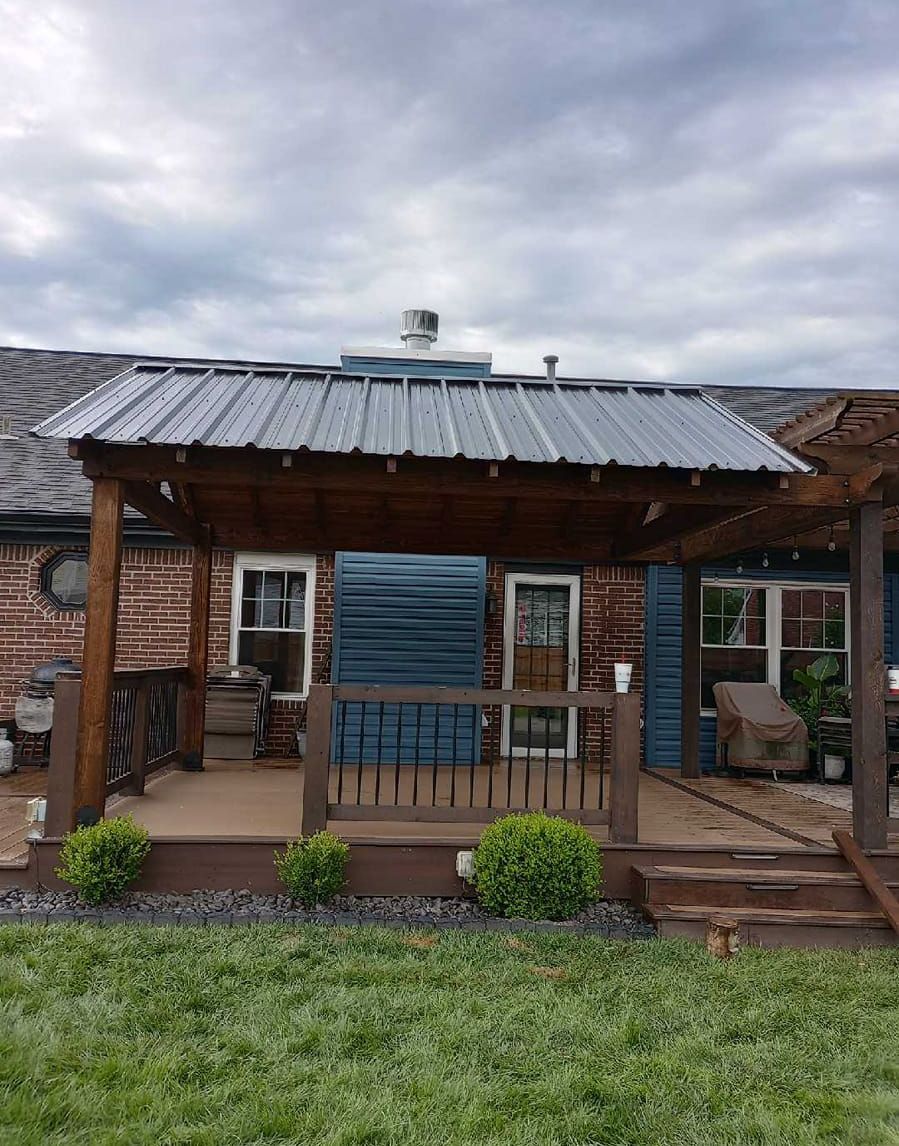 A house with a porch and a metal roof.