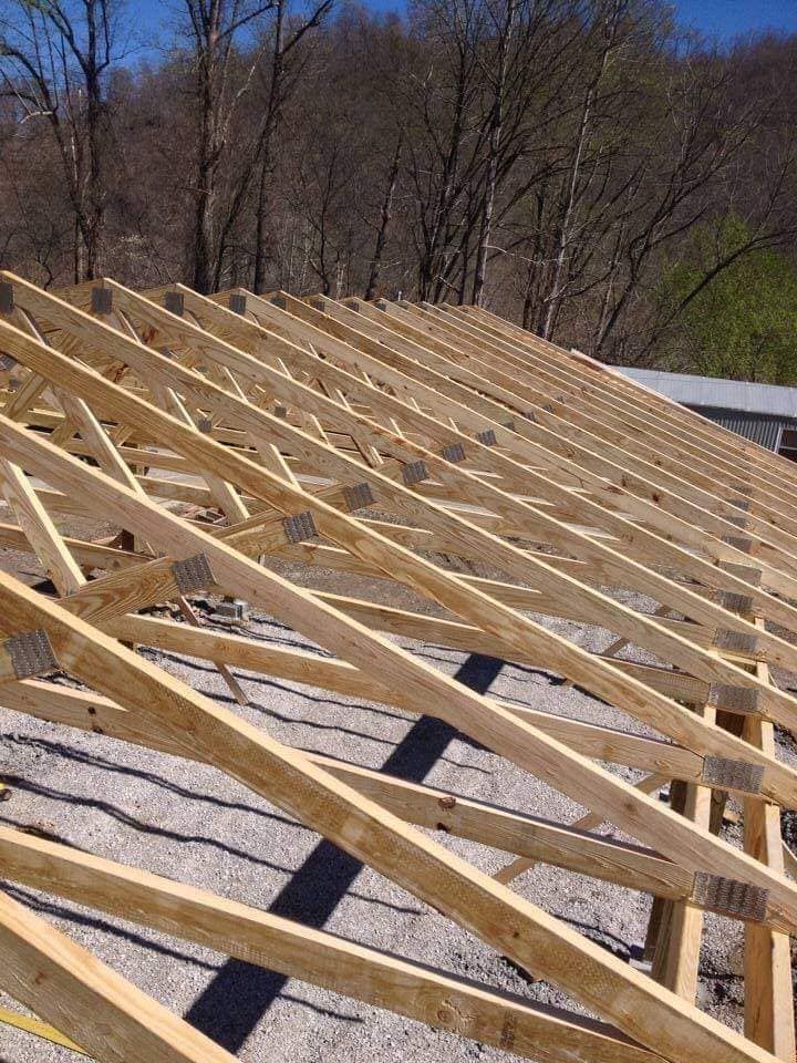 A roof is being built with wooden beams.