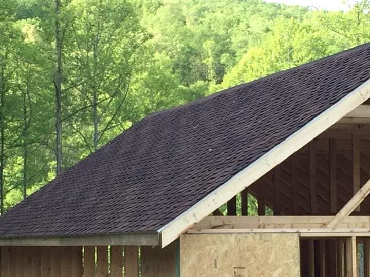 A house under construction with a black roof
