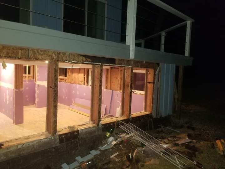 A house is being built at night with a lot of windows.