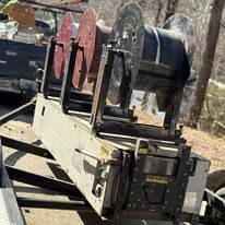 A bunch of spools of wire are sitting on top of a trailer.