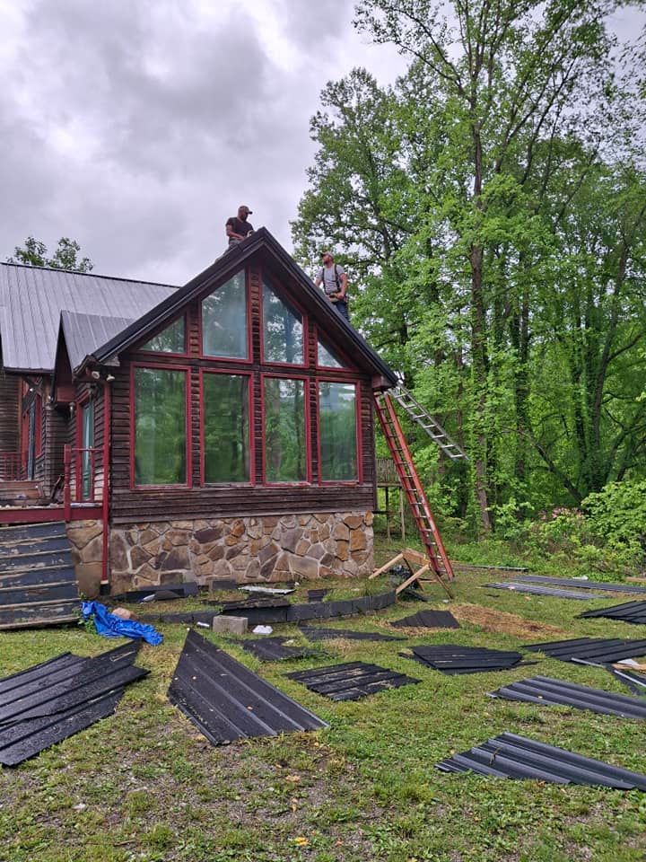 A man is standing on the roof of a house.