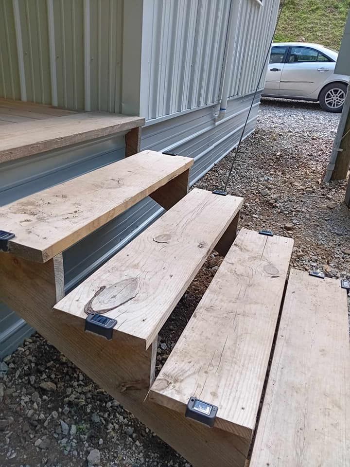 A wooden staircase with a car parked in the background.