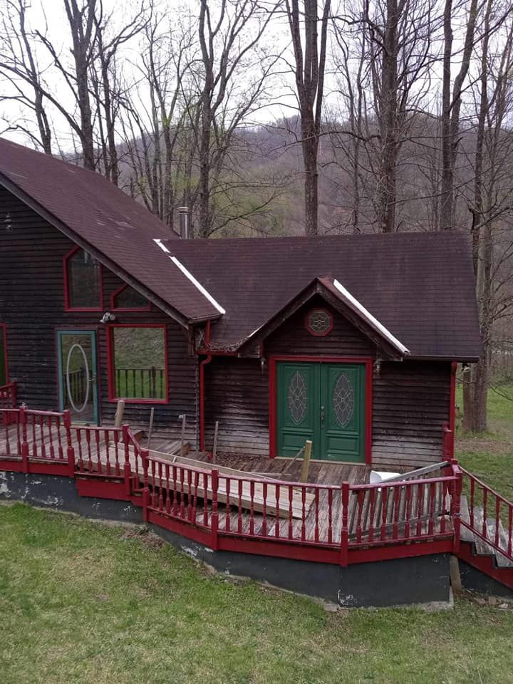 A house with a red deck and green doors