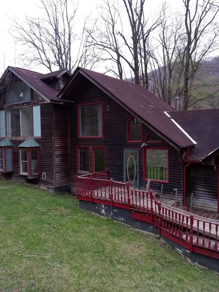 A large house with a red roof and a red porch