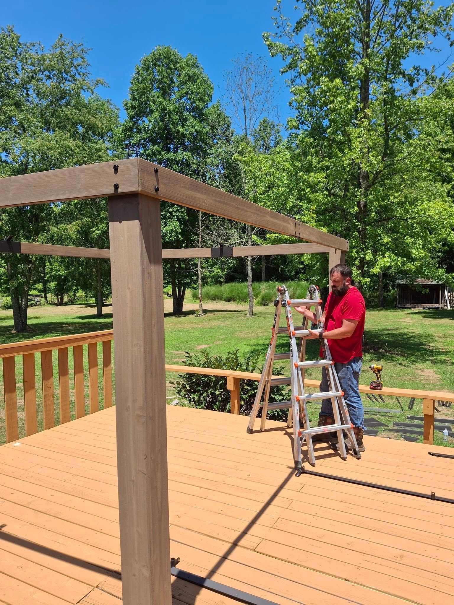 A man is standing on a ladder on a deck.